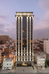 a tall building with lights on top of it at Three Points Musalli Makkah in Makkah