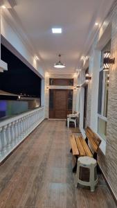a hallway with a bench and a flat screen tv at Smart Chalet:سمارت شالية in Salalah