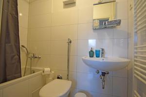 a bathroom with a sink and a toilet and a shower at Air Apartments 10 in Bremen