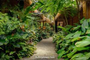 a path in a garden with a bunch of plants at Phi Phi CoCo Beach Resort in Phi Phi Islands
