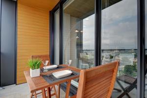 a dining room with a table and chairs on a balcony at Les Immeubles Charlevoix - Le 760-431 in Quebec City