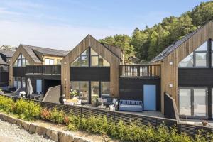 a modern house with a large deck and windows at Paradis på Sørlandet in Kristiansand