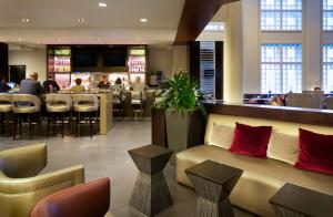 a hotel lobby with a couch and a bar at Hyatt Regency Boston in Boston