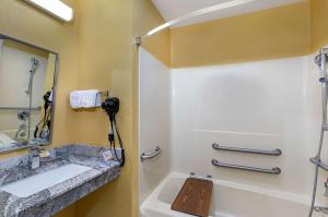 a bathroom with a sink and a shower with a mirror at Super 8 by Wyndham Eddyville/Kuttawa in Eddyville +42 photos