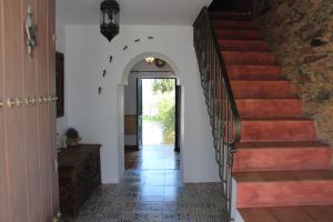 un pasillo de una casa con escalera y puerta en CASA MARGARITA en El Castillo de las Guardas
