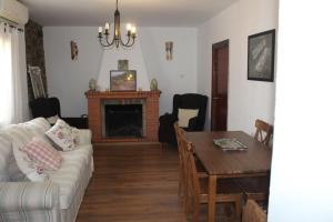 a living room with a couch and a table at CASA MARGARITA in El Castillo de las Guardas
