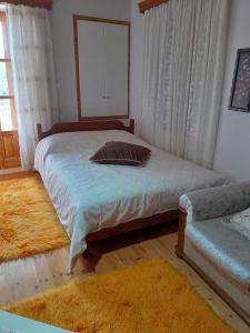 a bedroom with a large bed and a mirror at Agios Petros Studio in Áyios Pétros