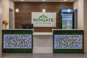 a winery counter with a refrigerator in a store at Wingate by Wyndham Waldorf - Washington DC Area in Waldorf