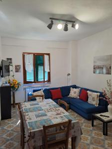 a living room with a blue couch and a table at Casa di Gian in Levanto