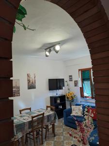 a living room with a table and a blue couch at Casa di Gian in Levanto