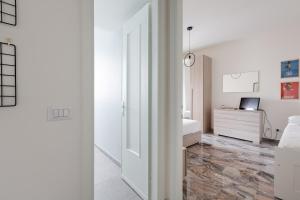 um quarto branco com uma cama e uma secretária em Dergano Comfy Apartment - 250 m far from M3 em Milão