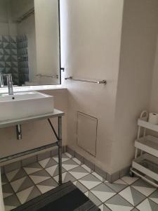 a bathroom with a sink and a mirror at LM Loft Maboneng in Johannesburg +11 photos