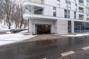 a building with a parking lot in front of it at Baltiq Plaza - BillBerry Apartments in Gdynia