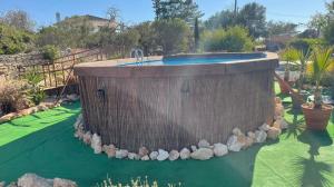 a swimming pool in a yard with rocks around it at Hakuna matata in Benagil