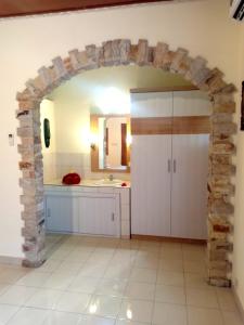 an archway in a kitchen with a sink at Sawah Lovina in Lovina