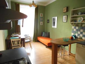 a kitchen and living room with a couch and a table at Appartment Nezamyslova II in Prague
