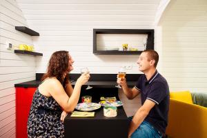 a man and a woman sitting at a table with wine glasses at Au Vieux Moulin 