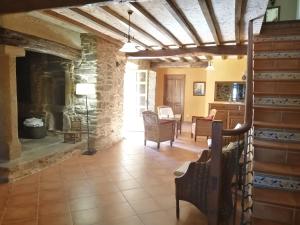 una gran sala de estar con chimenea de piedra. en Casa rural osvilares, en Santiago de Compostela