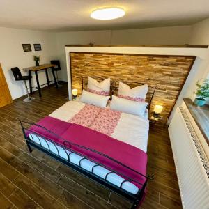 a large bed in a room with a brick wall at Ferienwohnung Melise in Reutte