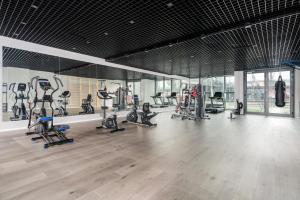a gym with several treadmills and exercise bikes at 16th Floor Towarowa 39 City Center Avenida by Renters Prestige in Poznań