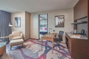 a hotel room with a desk and a chair at Crowne Plaza Manila Galleria, an IHG Hotel in Manila