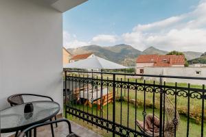 a balcony with a view of a field and mountains at Apartments Gudelj in Kamenari