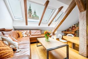 a living room with a couch and a table at Malostranská Residence in Prague