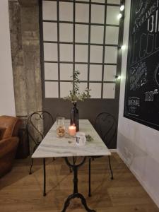 a table with a candle and a vase on it at Baptiste le caviste in Talence