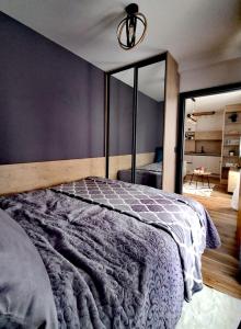 a bedroom with a large bed and a large mirror at Apartman 12 - Jahorina in Jahorina