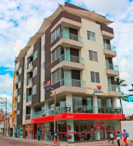 a tall building with people walking in front of it at Hotel Guaitipan Plaza in Pitalito