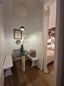 a small room with a table and a bed at Alixe la styliste in Talence +4 photos
