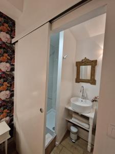 a bathroom with a glass shower and a sink at Alixe la styliste in Talence