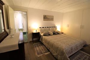 a bedroom with a bed and a table and a window at San Marco charming apartment with canal view in Venice