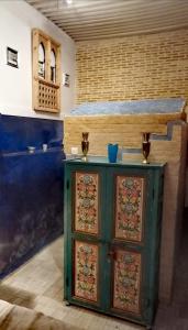 a kitchen with a green cabinet in a room at Les Bains de Fez Tara in Fez