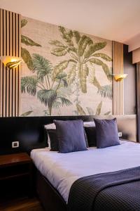 - une chambre avec un grand lit et une fresque murale dans l'établissement Hôtel Gallia Cannes, à Cannes