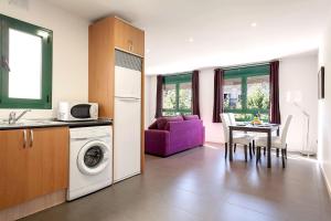 a kitchen and living room with a washing machine at Barcelona Comtal Apartments in Barcelona