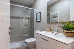 a bathroom with a toilet and a sink and a shower at BNBHolder Ponzano & Chamberi I in Madrid