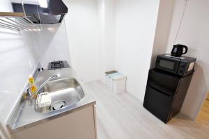 Η κουζίνα ή μικρή κουζίνα στο オーシャンテラス瀬底203