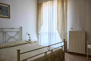 Postel nebo postele na pokoji v ubytování Appartamento Olimpia-Centralissimo-Pochi passi dal mare