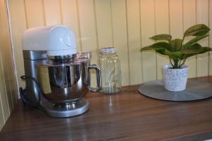 a mixer sitting on a table next to a plant at Cozy Country House in Spydeberg