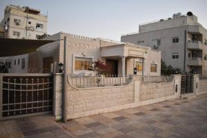 a house with a fence in front of a building at Aqaba Escape 1 in Aqaba