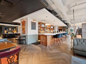 a bar in a restaurant with chairs and tables at Lavish Condo steps to Great All American Ball Park 502 in Cincinnati