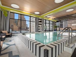 a swimming pool on the roof of a building at Lavish Condo steps to Great All American Ball Park 502 in Cincinnati