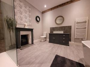 a bathroom with a fireplace and a sink at La Houlardais in Soucé