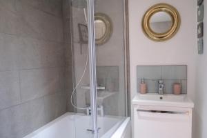 a bathroom with a shower with a sink and a toilet at Converted Stable with Hot Tub in Ilkley