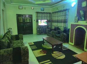 a living room with a couch and a table and a tv at 2 br own compound furnished hse in Nairagie Ngare