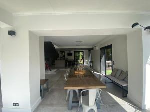 a dining room and living room with a table and chairs at VILLA BEL AIR CANNES - 240m2 - Freshly completely renovated - Beach - Pool - No Party allowed - No bachelor-ette stay - 25 mn walk from beach and Palais des festivals in Cannes
