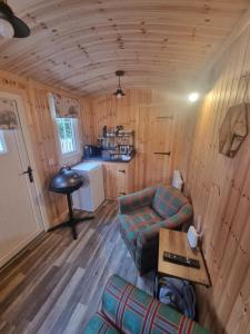 a living room with a couch and a table in a cabin at Blair snug hut in Kelty