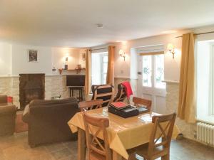 a living room with a table and a fireplace at Bridge Cottage in Mitchel Troy