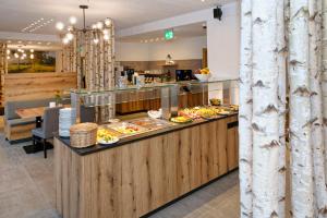 a buffet in a restaurant with food on a counter at Hotel 17 Seen in Eggstätt